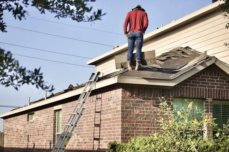 Professional roofer working on a residential roof in Sterling